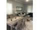 Elegant dining room featuring a chandelier, sleek furniture, and modern decor at 2300 Painter Ln, Kissimmee, FL 34741