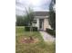 Charming single-story home featuring a tiled roof, a landscaped yard, and a welcoming front entrance at 2300 Painter Ln, Kissimmee, FL 34741