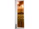 Elegant glass cabinet showcasing decorative glassware with brass hardware in this home's kitchen at 2300 Painter Ln, Kissimmee, FL 34741