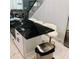 Modern kitchen with white cabinets and black marble island with seating at 2300 Painter Ln, Kissimmee, FL 34741