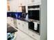 The stainless steel kitchen appliances with white cabinetry and brass hardware at 2300 Painter Ln, Kissimmee, FL 34741
