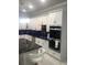 Kitchen with marble countertops, white cabinets, stainless steel appliances and island at 2300 Painter Ln, Kissimmee, FL 34741