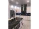 Modern kitchen features white cabinets, marble countertops, stainless steel appliances, and pendant lighting at 2300 Painter Ln, Kissimmee, FL 34741