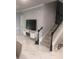 Bright living room featuring elegant marble floors, staircase, and modern floating entertainment center at 2300 Painter Ln, Kissimmee, FL 34741