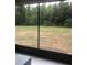 Screened-in patio featuring a tranquil view of the spacious yard and surrounding greenery at 2300 Painter Ln, Kissimmee, FL 34741