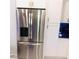 Modern stainless steel refrigerator with a water dispenser and white cabinets in this updated kitchen at 2300 Painter Ln, Kissimmee, FL 34741