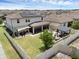 A high angle shot of the property highlighting its solar panels, fenced yard, patio, and pergola at 2751 Matera Dr, St Cloud, FL 34771