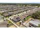 Bird's-eye view of the neighborhood featuring manicured lawns, tree-lined streets, and neatly arranged homes at 2751 Matera Dr, St Cloud, FL 34771