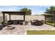 Backyard featuring an outdoor lounge, dining area, fire pit, and manicured grass, ideal for relaxation at 2751 Matera Dr, St Cloud, FL 34771