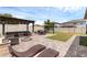 Backyard with a lounge area, fire pit, dining table, and landscaped yard, perfect for outdoor entertaining at 2751 Matera Dr, St Cloud, FL 34771