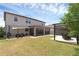 Expansive backyard features a covered patio, grilling area, and pergola seating for outdoor relaxation and entertaining at 2751 Matera Dr, St Cloud, FL 34771