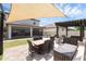 Backyard showcasing an outdoor lounge, dining table, fire pit and sunshade; great for outdoor gatherings at 2751 Matera Dr, St Cloud, FL 34771