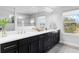 This bathroom features a dual sink vanity with a white countertop, modern fixtures and a large mirror at 2751 Matera Dr, St Cloud, FL 34771