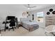 This bedroom features a neutral palette, a ceiling fan, a skateboard, a desk and a double bed at 2751 Matera Dr, St Cloud, FL 34771