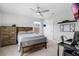 Comfortable bedroom with wood furniture, ceiling fan, neutral colors, and a desk area at 2751 Matera Dr, St Cloud, FL 34771