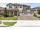 Beautiful two-story home with a three-car garage and well-maintained lawn and paver driveway at 2751 Matera Dr, St Cloud, FL 34771