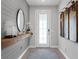 Inviting foyer with decorative wall paneling, stylish mirror and a patterned entrance rug at 2751 Matera Dr, St Cloud, FL 34771