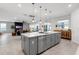 Spacious open kitchen with island, pendant lights, and easy access to the living room at 2751 Matera Dr, St Cloud, FL 34771