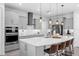 The contemporary kitchen features gray cabinets, quartz countertops, and stainless steel appliances at 2751 Matera Dr, St Cloud, FL 34771