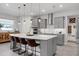 Modern kitchen with gray cabinets, white countertops, stainless steel appliances and a breakfast bar at 2751 Matera Dr, St Cloud, FL 34771