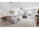 This living room features neutral decor, a large sectional sofa, a dining area and many windows at 2751 Matera Dr, St Cloud, FL 34771