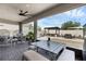 Covered patio featuring outdoor seating, including egg chairs, a dining table, and a view of the backyard at 2751 Matera Dr, St Cloud, FL 34771