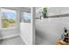 This bathroom features a frameless shower with modern tile, a window, and a built-in niche for toiletries at 2751 Matera Dr, St Cloud, FL 34771