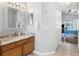 Neutral bathroom with marble countertop and a decorative mirror above the vanity at 3016 Samosa Hill Cir, Clermont, FL 34714