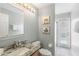 Bright bathroom with a granite countertop, elegant mirror and access to the pool area at 3016 Samosa Hill Cir, Clermont, FL 34714