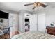 Comfortable bedroom featuring a ceiling fan, a TV, and doorway to a living area at 3016 Samosa Hill Cir, Clermont, FL 34714