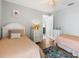 Cozy guest bedroom with two twin beds and decorative starfish accents at 3016 Samosa Hill Cir, Clermont, FL 34714