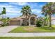 Charming single-story home with a well-manicured lawn and mature palm trees at 3016 Samosa Hill Cir, Clermont, FL 34714