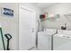 Practical laundry room equipped with modern washer and dryer for efficient cleaning at 3016 Samosa Hill Cir, Clermont, FL 34714