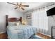 Main bedroom featuring large windows, hardwood floors, and ceiling fan at 3016 Samosa Hill Cir, Clermont, FL 34714