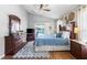 Serene main bedroom featuring comfortable bedding, wood floors, and abundant natural light at 3016 Samosa Hill Cir, Clermont, FL 34714