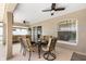 Comfortable covered patio features an outdoor dining set and ceiling fans at 3016 Samosa Hill Cir, Clermont, FL 34714