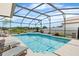 Gorgeous screened-in pool with a spa and lounge chairs for ultimate relaxation on a sunny day at 3016 Samosa Hill Cir, Clermont, FL 34714