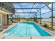 Relaxing screened-in pool and spa with a tranquil backyard view at 3016 Samosa Hill Cir, Clermont, FL 34714