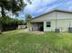 View of a backyard featuring green grass, patio, and exterior of home at 3327 Toasy Dr, Orlando, FL 32806