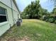 View of the backyard featuring green grass and mature trees at 3327 Toasy Dr, Orlando, FL 32806