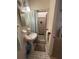 Small bathroom featuring a pedestal sink and tile shower with curtains at 3327 Toasy Dr, Orlando, FL 32806