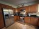 Charming kitchen boasts stainless steel refrigerator, granite countertops and wood cabinets at 3327 Toasy Dr, Orlando, FL 32806