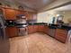 Well-lit kitchen features stainless steel appliances, granite countertops, and tile backsplash at 3327 Toasy Dr, Orlando, FL 32806