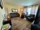 Inviting living room features a comfortable couch, complementary armchair and a decorative area rug at 3327 Toasy Dr, Orlando, FL 32806