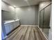 The primary bathroom features double sinks, a large mirror, and a separate glass-enclosed shower at 4009 Maggie Loop, Lakeland, FL 33813