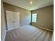 Carpeted bedroom with natural light. Features a closet and neutral paint at 4009 Maggie Loop, Lakeland, FL 33813