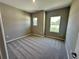 Bright bedroom with neutral colors, large windows, and plush carpeting at 4009 Maggie Loop, Lakeland, FL 33813
