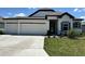 Charming single-story home featuring a three-car garage and a well-manicured lawn at 4009 Maggie Loop, Lakeland, FL 33813