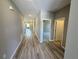 A long hallway with wood-look flooring connects the living spaces, bedrooms, and other areas of the house at 4009 Maggie Loop, Lakeland, FL 33813