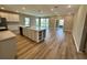 Open-concept kitchen features an island, white cabinetry, modern appliances, and plenty of countertop space at 4009 Maggie Loop, Lakeland, FL 33813